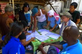 UN-Habitat technical team verifying the location of the houses on the map with community members. Photo by Beryl Jane Dela Cruz.