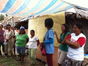Officers of Pawa homeowners association discuss their experiences with the People's Process in detail during the delegation's visit to their community.  Photo: UN-Habitat